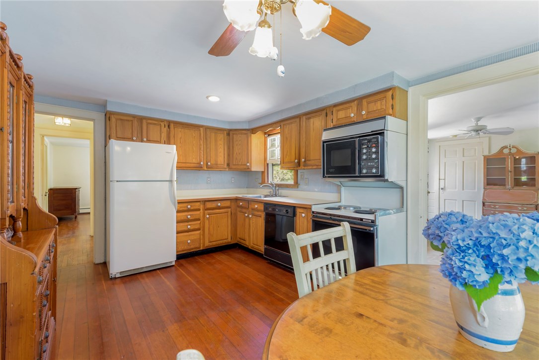 148 Beach Street Westerly, RI 02891 - Photo 9 of 25 Kitchen leading to hall full-bath and Bedrooms #1 & #2 on left and sun-room/Florida room on the right!