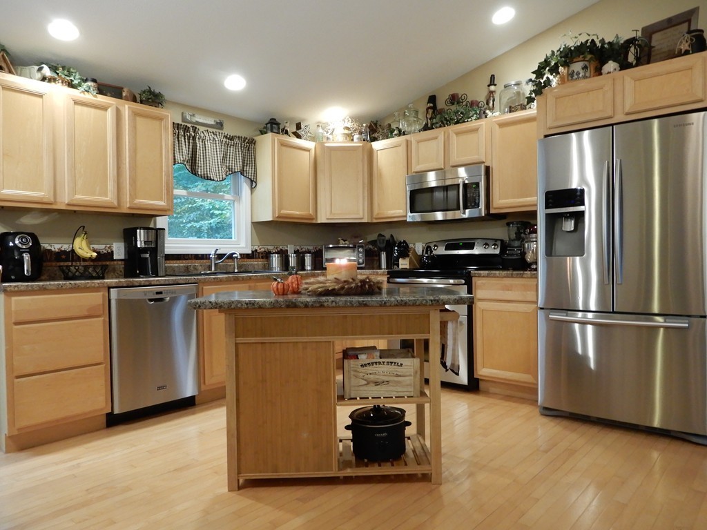 100 Crestwood Road Brimfield, MA 01010 - Photo 9 of 28 a kitchen with kitchen island granite countertop a refrigerator oven a sink dishwasher and white cabinets with wooden floor