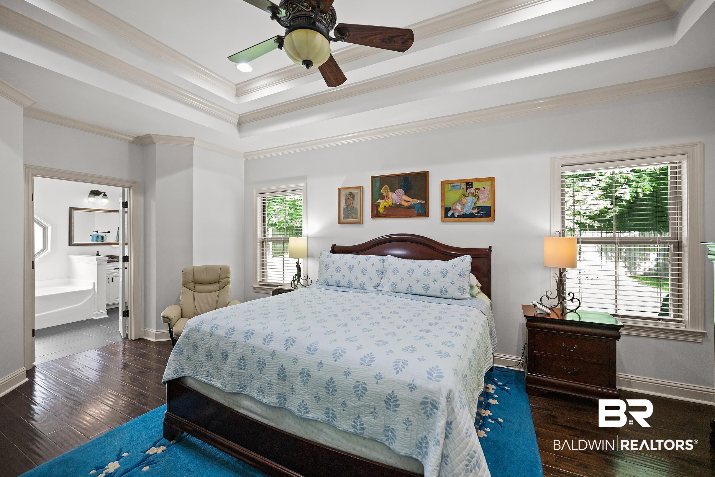313 Pecan Ridge Boulevard Fairhope, AL 36532 - Photo 45 of 51 Bedroom featuring rich wood-finish flooring, a detailed tray ceiling with a ceiling fan, and two windows with blinds