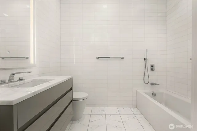 a bathroom with a sink a toilet and bathtub