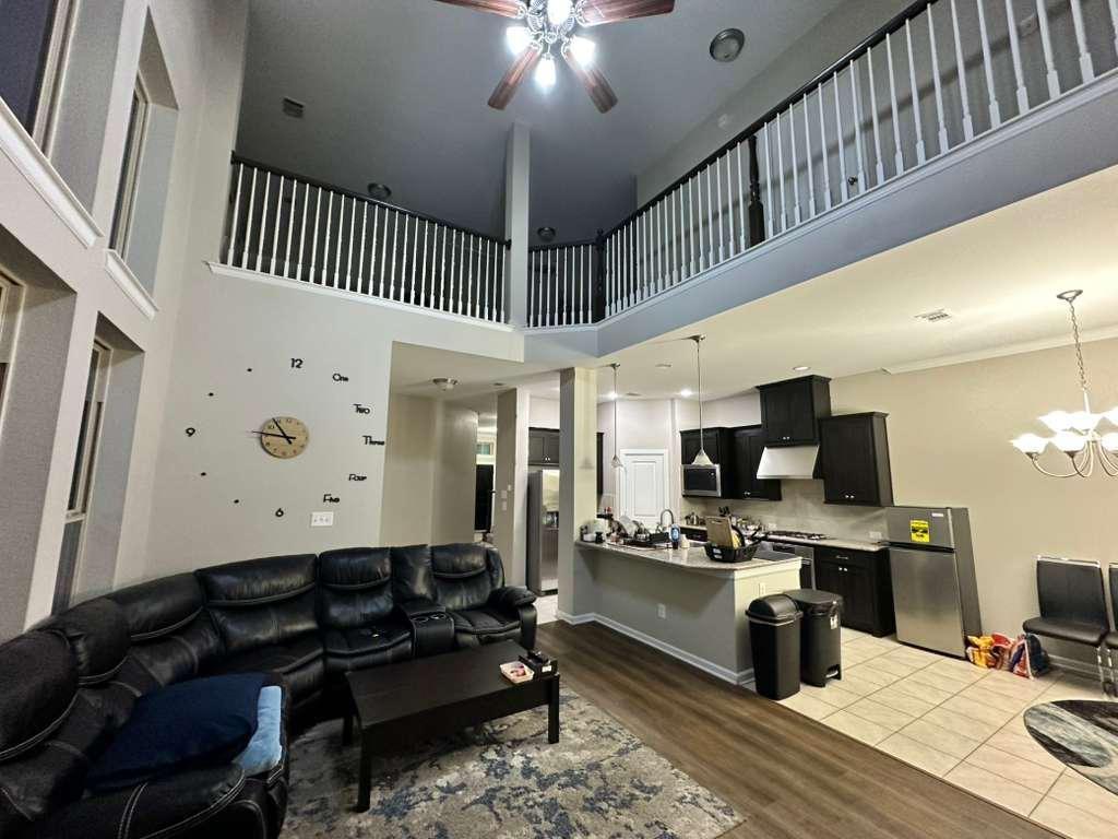 6655 DeLeon Street Irving, TX 75039 - Photo 4 of 10 a living room with stainless steel appliances kitchen island granite countertop furniture a rug and a window
