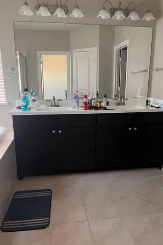 a bathroom with a sink a vanity and a mirror