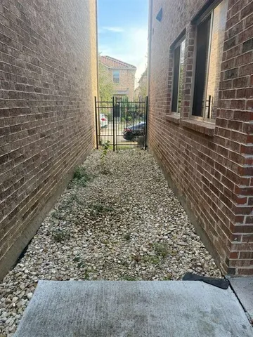 a view of a pathway both side of house