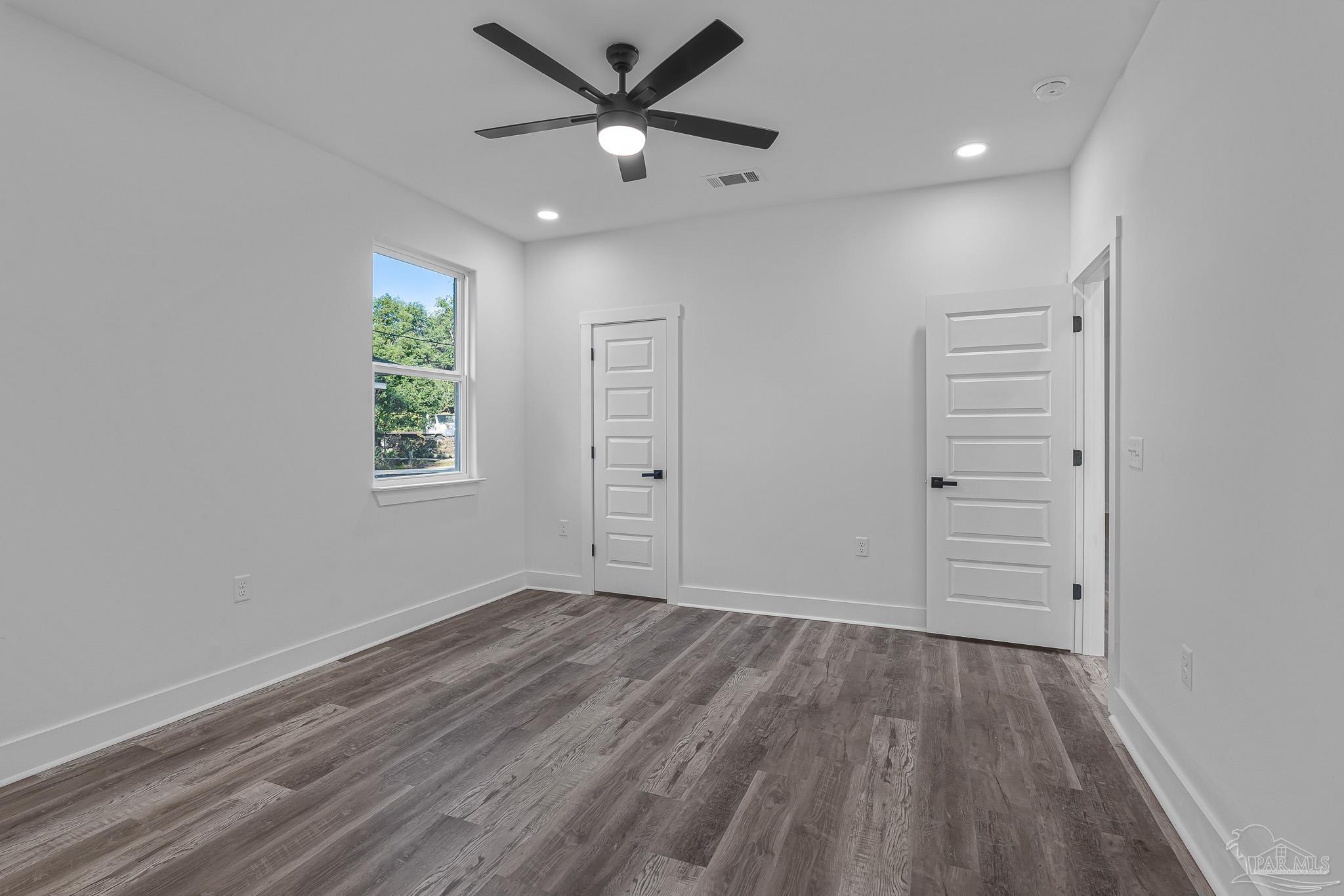 5005 Saufley Field Road Pensacola, FL 32526 - Photo 11 of 27 wooden floor in an empty room with a window