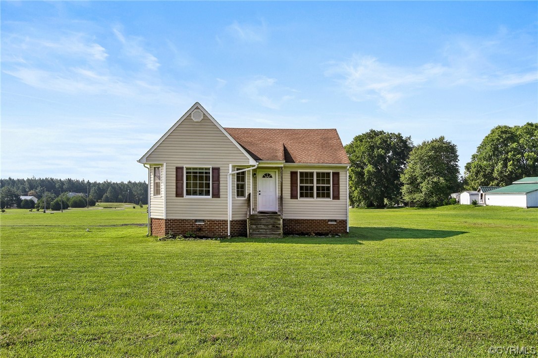 8376 Pine Acres Lane Carson, VA 23830 - Photo 1 of 21 a front view of a house with a garden