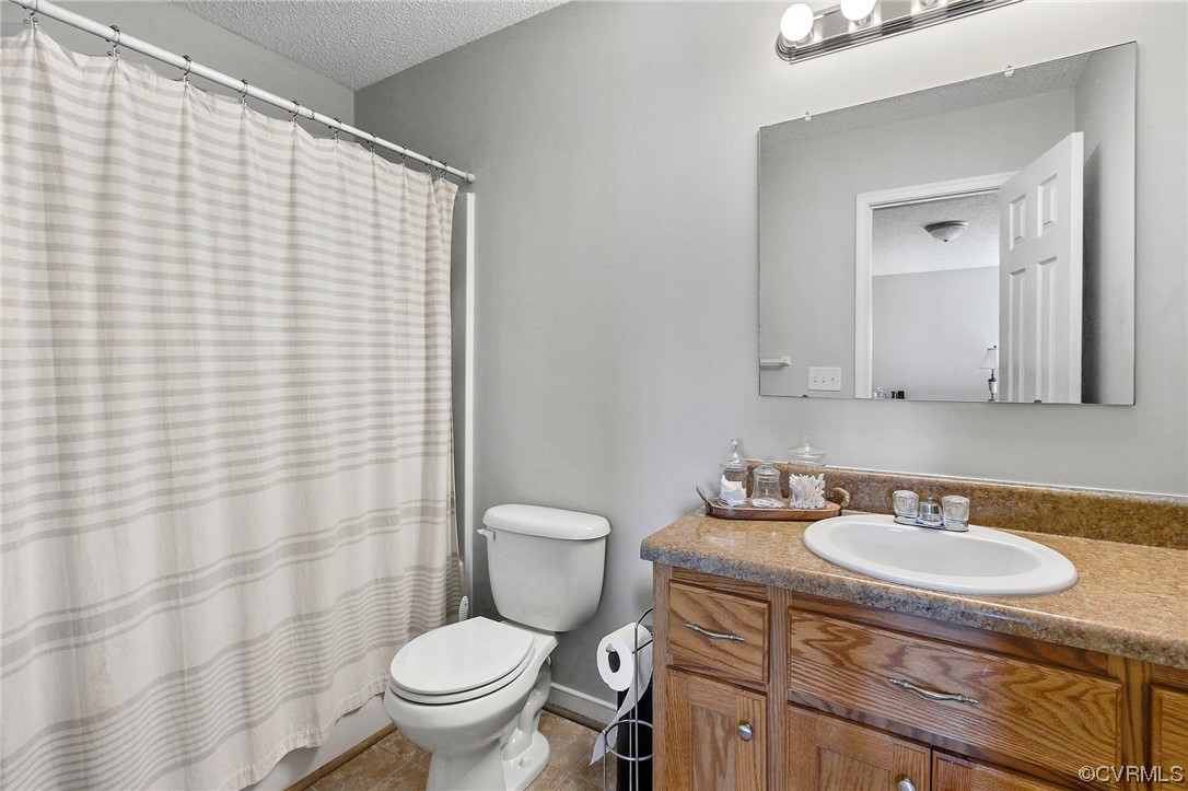 8376 Pine Acres Lane Carson, VA 23830 - Photo 15 of 21 a bathroom with a granite countertop sink toilet and mirror