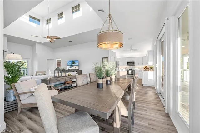 a view of a dining room with furniture a chandelier and wooden floor