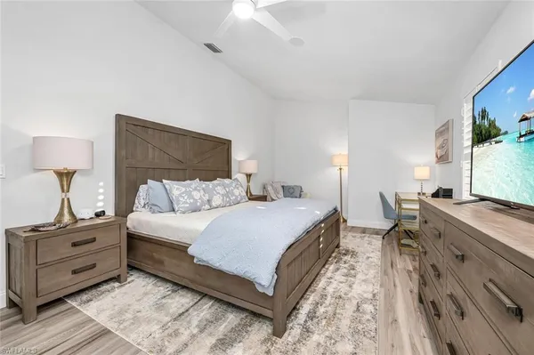 a bed room with a bed window and a mirror