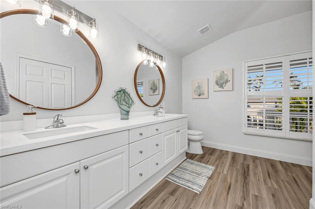 2736 Gulfview Drive Naples, FL 34112 - Photo 14 of 29 a bathroom with a toilet a sink and a mirror