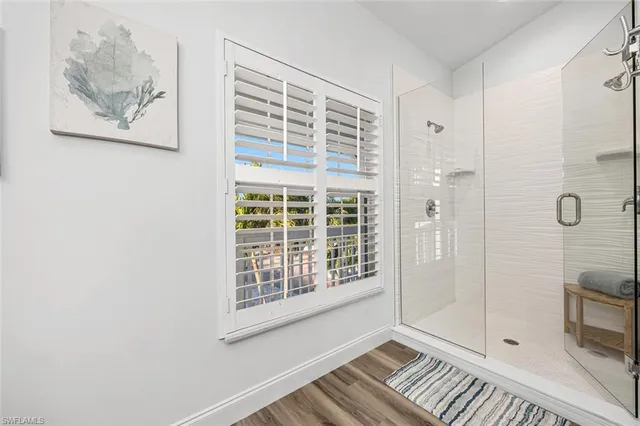 a view of wooden floor and bathroom in a room