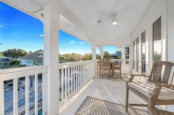 a view of a chairs and table in balcony