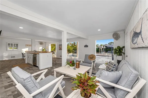 a living room with furniture fireplace and a window