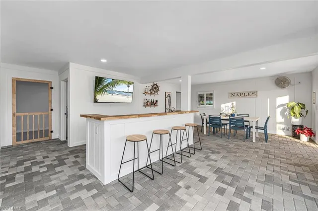 a living room with furniture a dining table and a large window