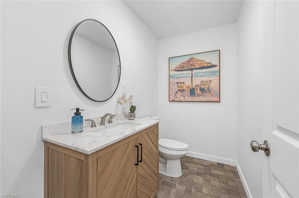 2736 Gulfview Drive Naples, FL 34112 - Photo 23 of 29 a bathroom with a sink and a mirror