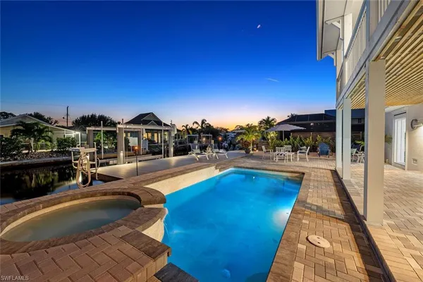 a view of a swimming pool and lounge chairs