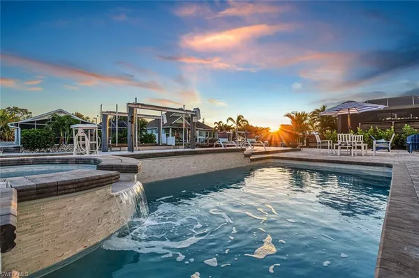 a view of swimming pool with outdoor seating and deck
