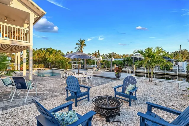 a view of a patio with couches chairs and potted plants