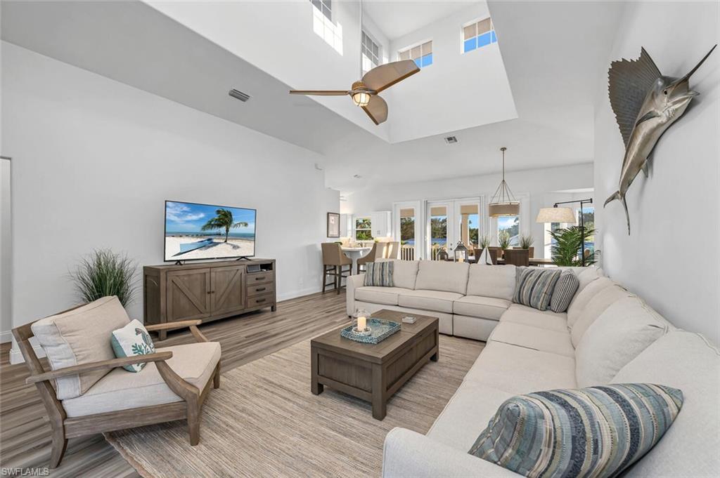 2736 Gulfview Drive Naples, FL 34112 - Photo 7 of 29 a living room with furniture kitchen view and a wooden floor