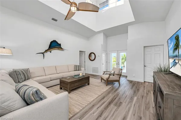 a living room with furniture and a wooden floor