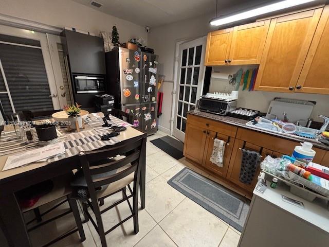 6300 Northwest 2nd Street Miami, FL 33126 - Photo 20 of 26 a kitchen with a table chairs stove and cabinets