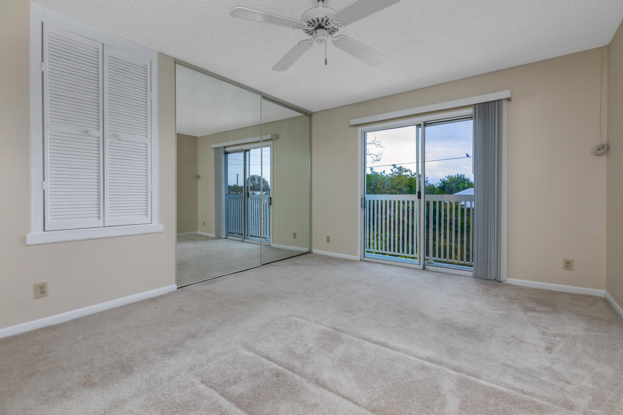 6262 Riverwalk Lane, Unit 5 Jupiter, FL 33458 - Photo 22 of 42 a view of empty room with window and ceiling fan