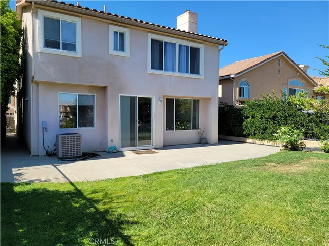 a swimming pool with outdoor seating and yard