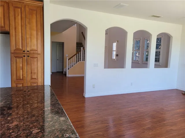 a view of a room with wooden floor and windows