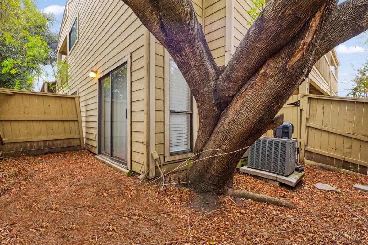 3502 Ocee Street, Unit 3502 Houston, TX 77063 - Photo 23 of 28 a view of backyard with a large tree and wooden fence