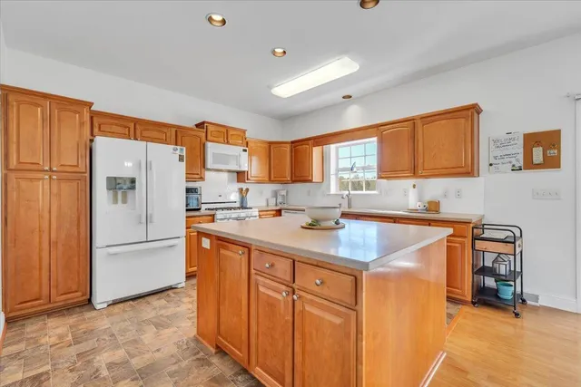 a living room with furniture a rug and white walls