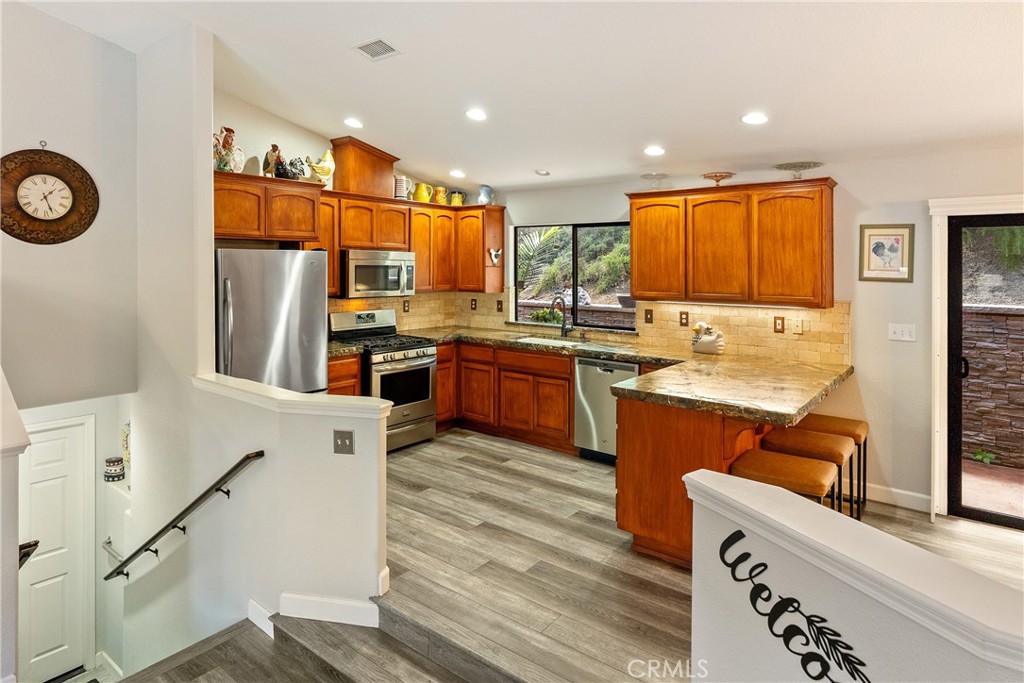 11625 Cenegal Road Atascadero, CA 93422 - Photo 13 of 65 The upgraded kitchen has laminate wood floors and plenty of cabinet space.