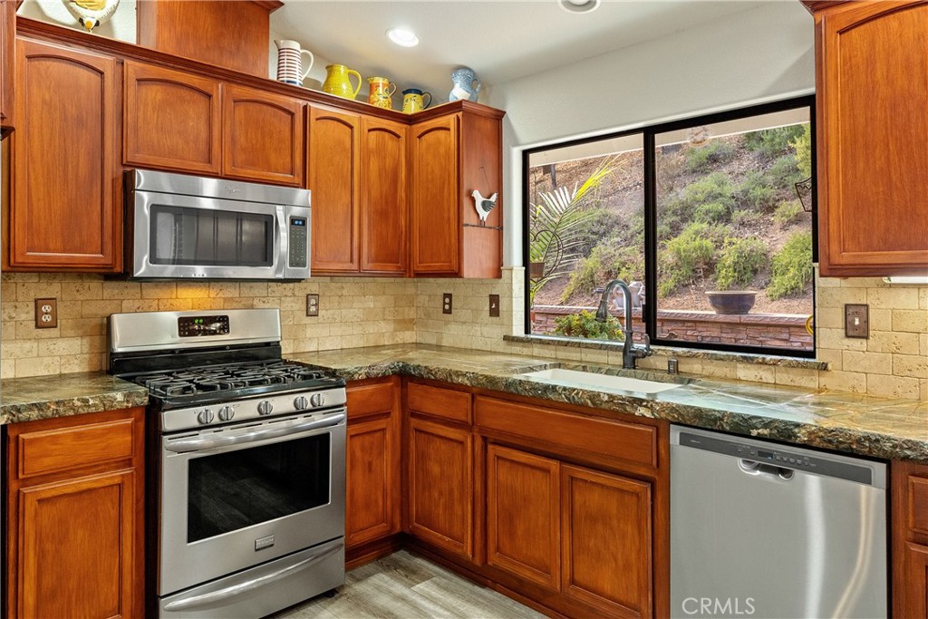 11625 Cenegal Road Atascadero, CA 93422 - Photo 14 of 65 Stainless steel appliances and gorgeous granite countertops with appealing live edge. Owners recently installed a brand new LG stove and microwave (not pictured).
