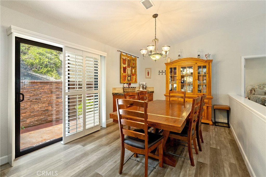 11625 Cenegal Road Atascadero, CA 93422 - Photo 16 of 65 The dining area has a chandelier, built-in buffet with the same granite countertop as the kitchen and a large sliding glass door with plantation shutters.