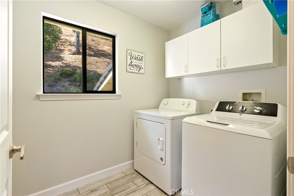 11625 Cenegal Road Atascadero, CA 93422 - Photo 24 of 65 The laundry room has cabinets above the washer and dryer and on the other side of the room. Washer and dryer stay!