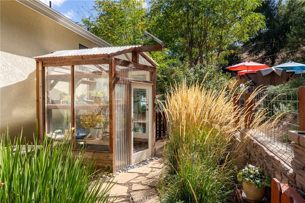 11625 Cenegal Road Atascadero, CA 93422 - Photo 42 of 65 On the backside of the home we find a greenhouse that has been made from recycled materials.