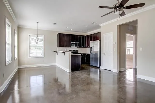 a view of kitchen with sink microwave refrigerator and cabinets
