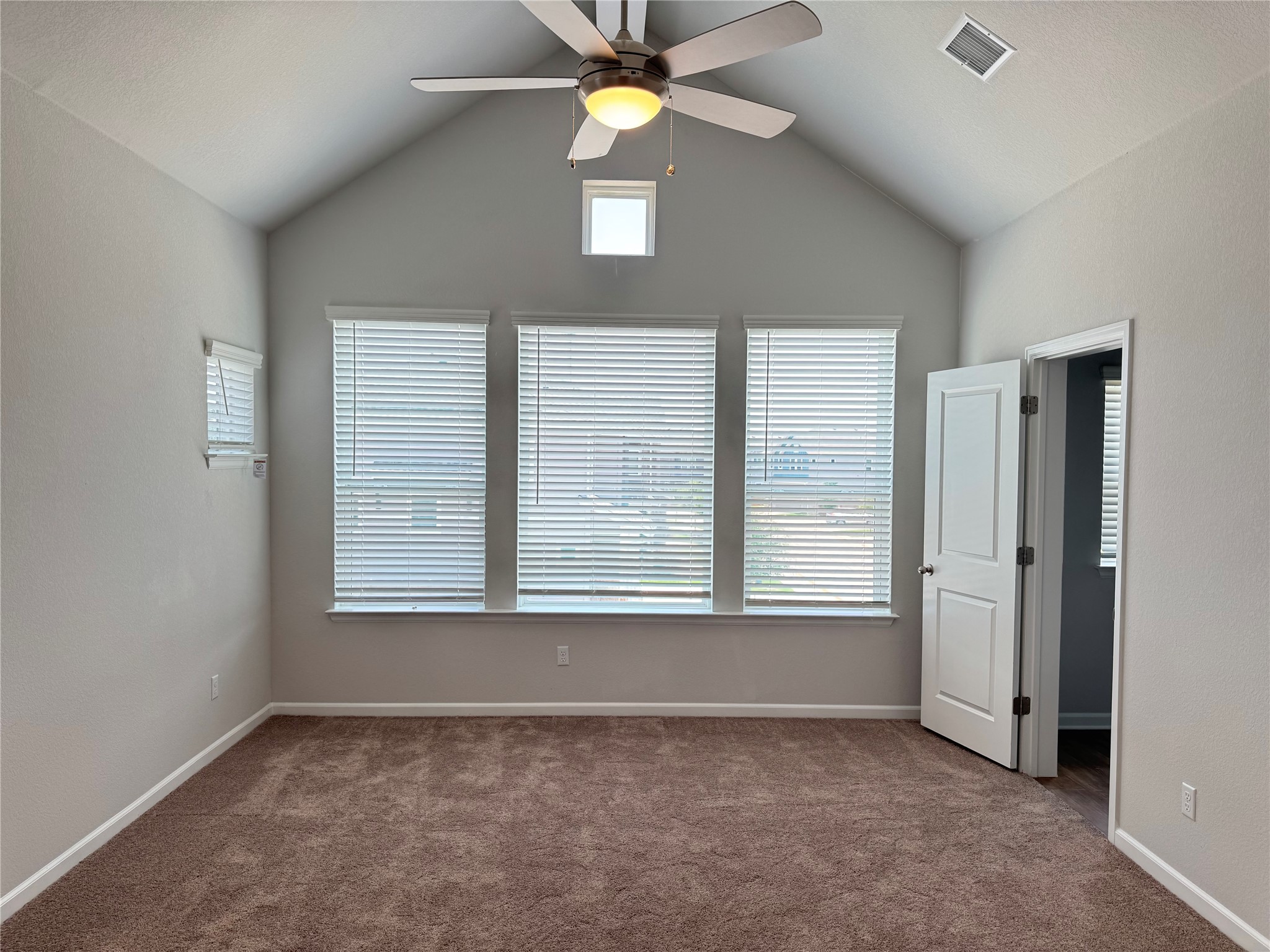 3000 Chisholm Trail Road, Unit 41 Round Rock, TX 78681 - Photo 9 of 28 A comfortable bedroom boasts vaulted ceilings and ample natural light from multiple windows.