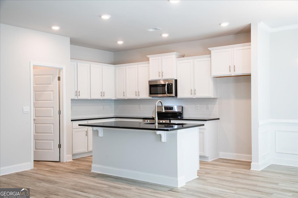 361 Eagle Ridge Road Macon, GA 31216 - Photo 14 of 50 a kitchen with kitchen island stainless steel appliances a sink and a counter top space