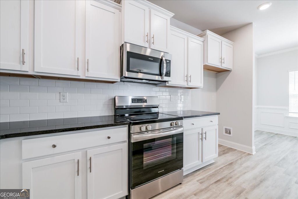 361 Eagle Ridge Road Macon, GA 31216 - Photo 18 of 50 a kitchen with stainless steel appliances granite countertop grey cabinets a stove a sink and dishwasher