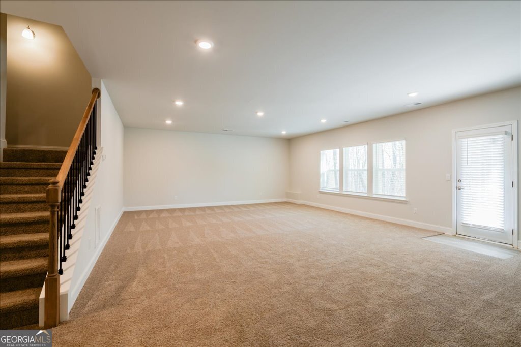 361 Eagle Ridge Road Macon, GA 31216 - Photo 43 of 50 a view of an empty room with wooden floor and windows