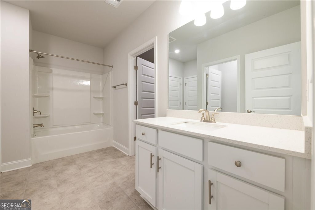 361 Eagle Ridge Road Macon, GA 31216 - Photo 46 of 50 a bathroom with a sink double vanity granite tub shower and a mirror