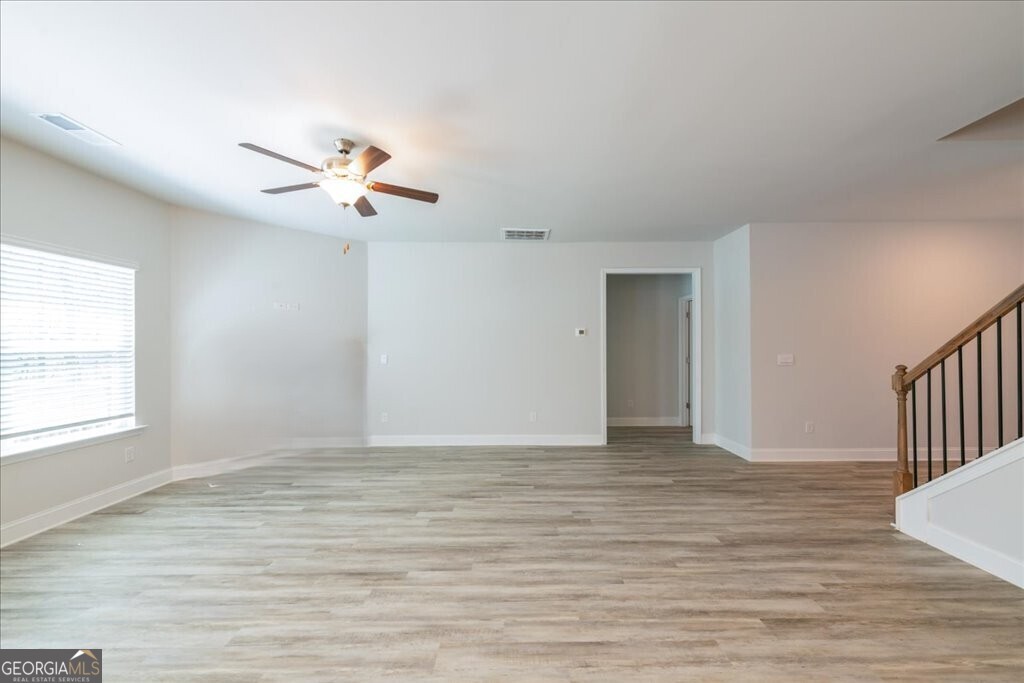 361 Eagle Ridge Road Macon, GA 31216 - Photo 7 of 50 a view of an empty room with a window and wooden floor