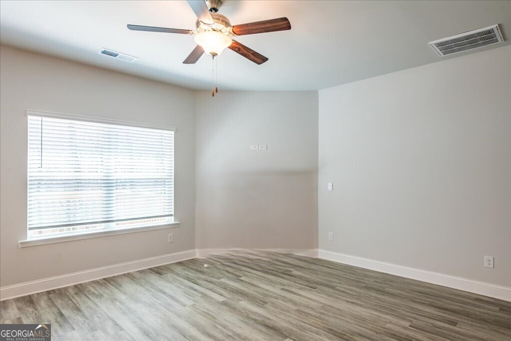 361 Eagle Ridge Road Macon, GA 31216 - Photo 8 of 50 a view of an empty room with wooden floor and a window