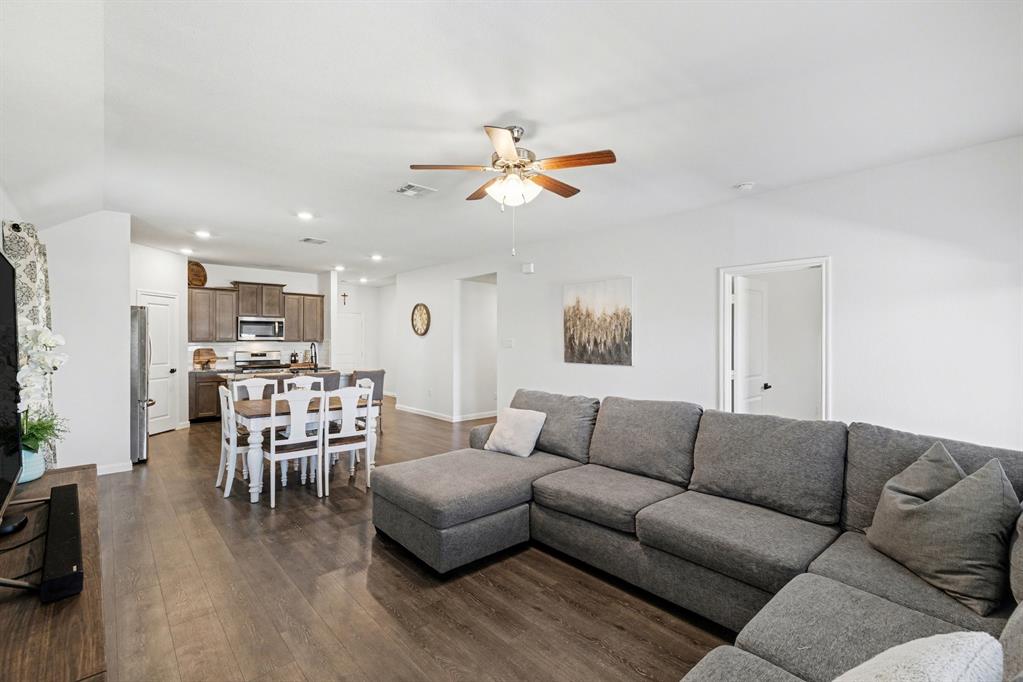 706 Spur Ridge Princeton, TX 75407 - Photo 11 of 38 a living room with furniture kitchen view and a wooden floor