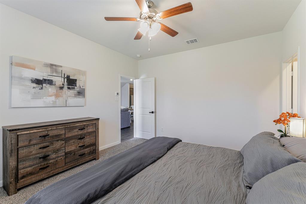 706 Spur Ridge Princeton, TX 75407 - Photo 21 of 38 a bedroom with a bed and furniture