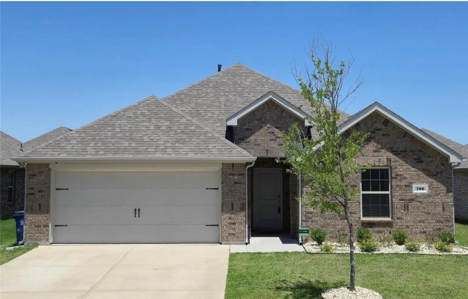 706 Spur Ridge Princeton, TX 75407 - Photo 2 of 38 a front view of a house with a yard and garage