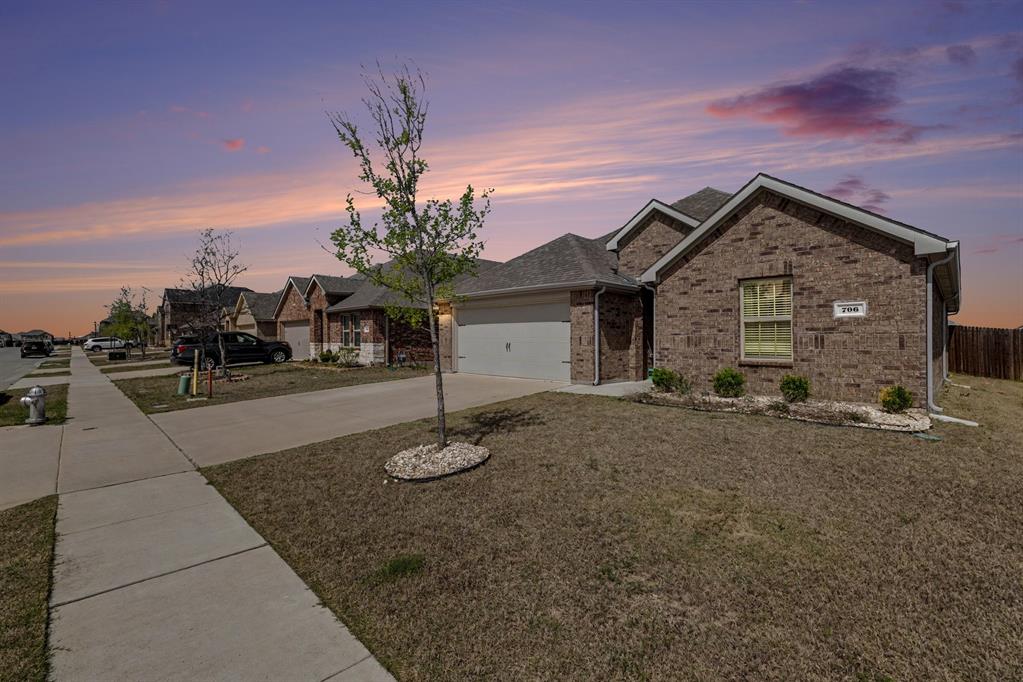 706 Spur Ridge Princeton, TX 75407 - Photo 37 of 38 a front view of a house with a yard and garage