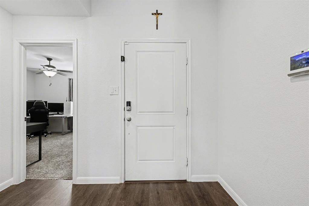 706 Spur Ridge Princeton, TX 75407 - Photo 8 of 38 a view of a hallway with wooden floor and closet