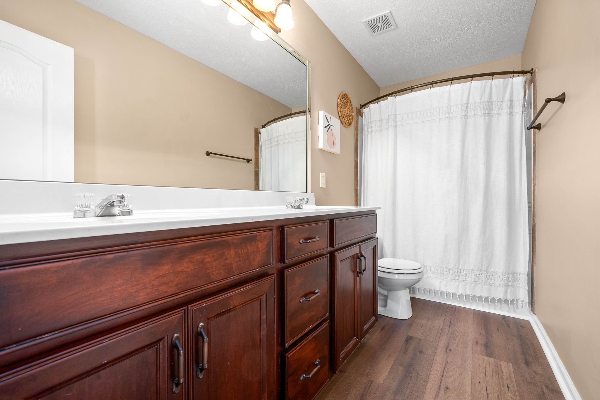 3771 Suiter Road Clarksville, TN 37040 - Photo 22 of 28 a spacious bathroom with a double vanity sink toilet and a mirror
