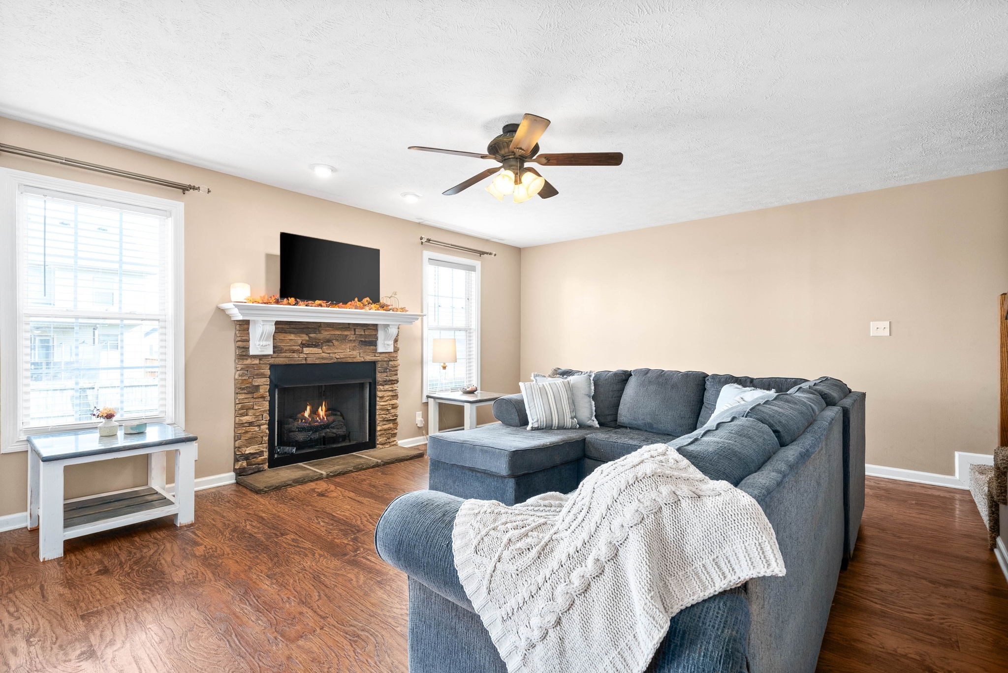 3771 Suiter Road Clarksville, TN 37040 - Photo 6 of 28 a living room with furniture a fireplace and a flat screen tv