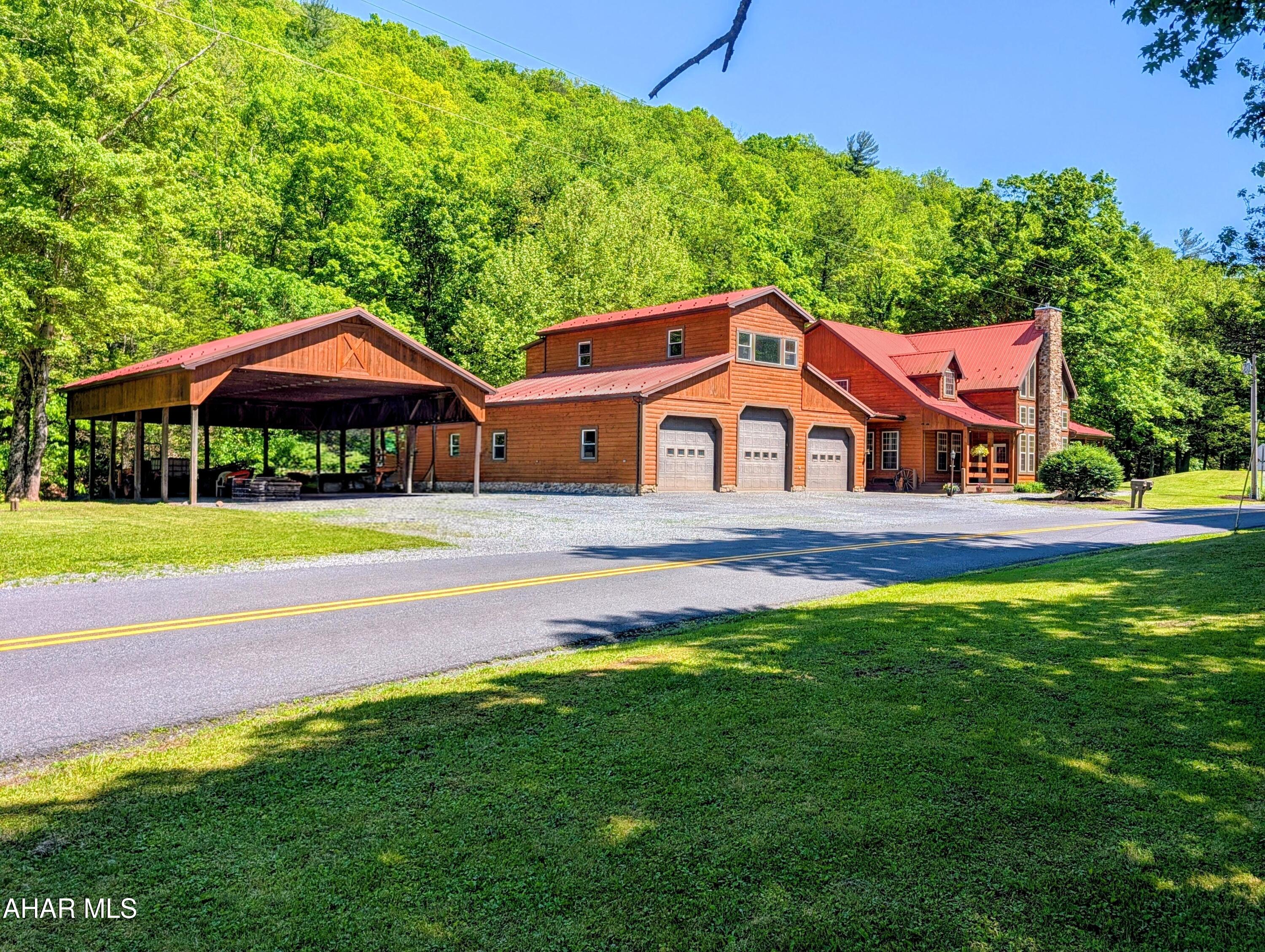 213 Sherman Valley Road Hopewell, PA 16650 - Photo 2 of 104 a front view of a house with swimming pool and yard